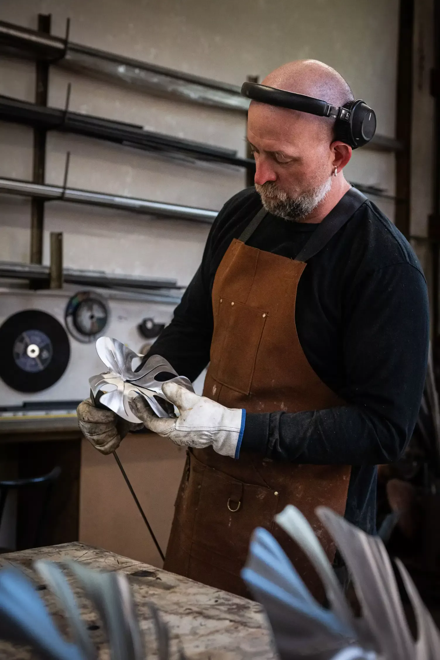 Artist heating a monstera leaf with a torch